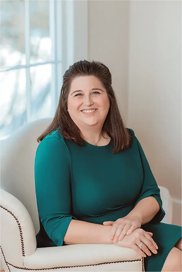 Smiling psychologist and career development coach seated in a bright office